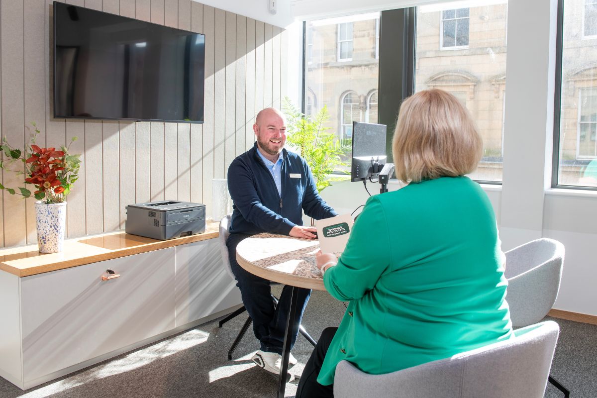 Cumberland colleague with a customer in The Cumberland's English Street branch in Carlisle.